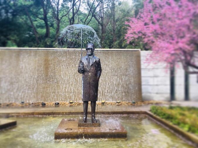 modern art fountain man in the rain